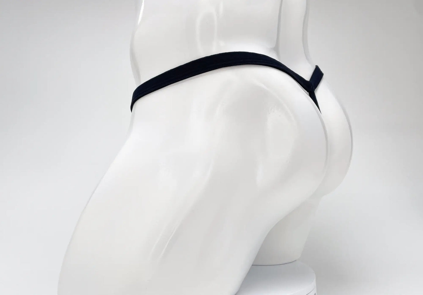 Black elastic waistband thong on white mannequin wildmant modal micro thong big boy pouch purple