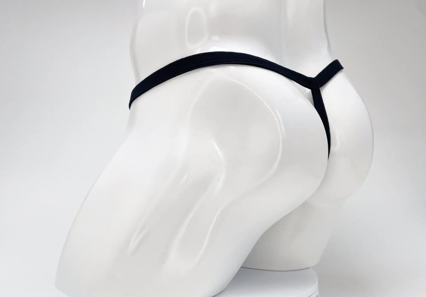 Wildmant modal micro thong in purple with a minimalist design and big boy pouch shown from the back side