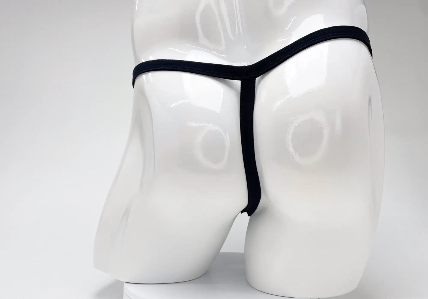 Wildmant modal micro black thong with big boy pouch displayed on white mannequin front view