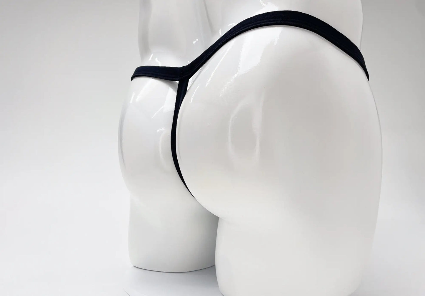 Wildmant modal micro thong big boy pouch in black displayed on a white mannequin highlighting the front view