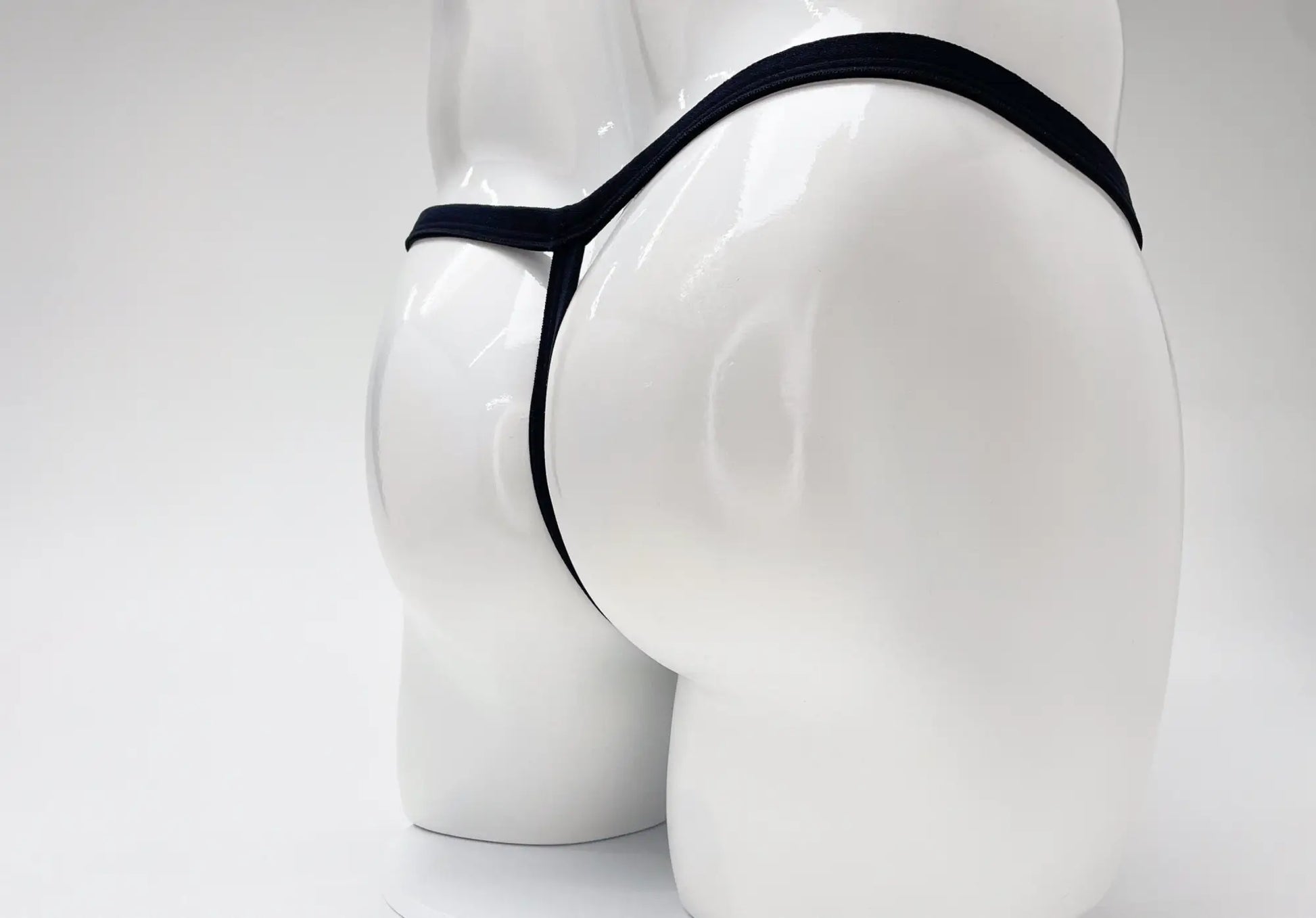 Wildmant modal micro thong big boy pouch in black displayed on a white mannequin highlighting the front view