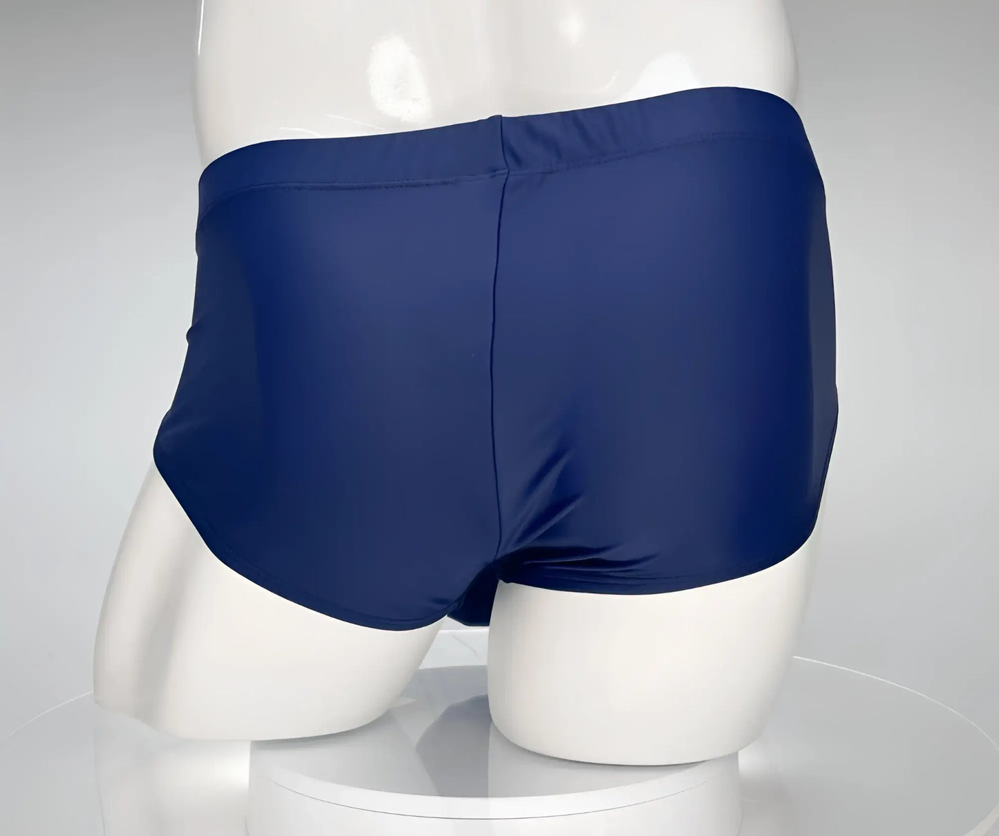 Wildmant monster cock swim brief navy in navy blue with smooth stretchy fabric and simple back seam shown from back side
