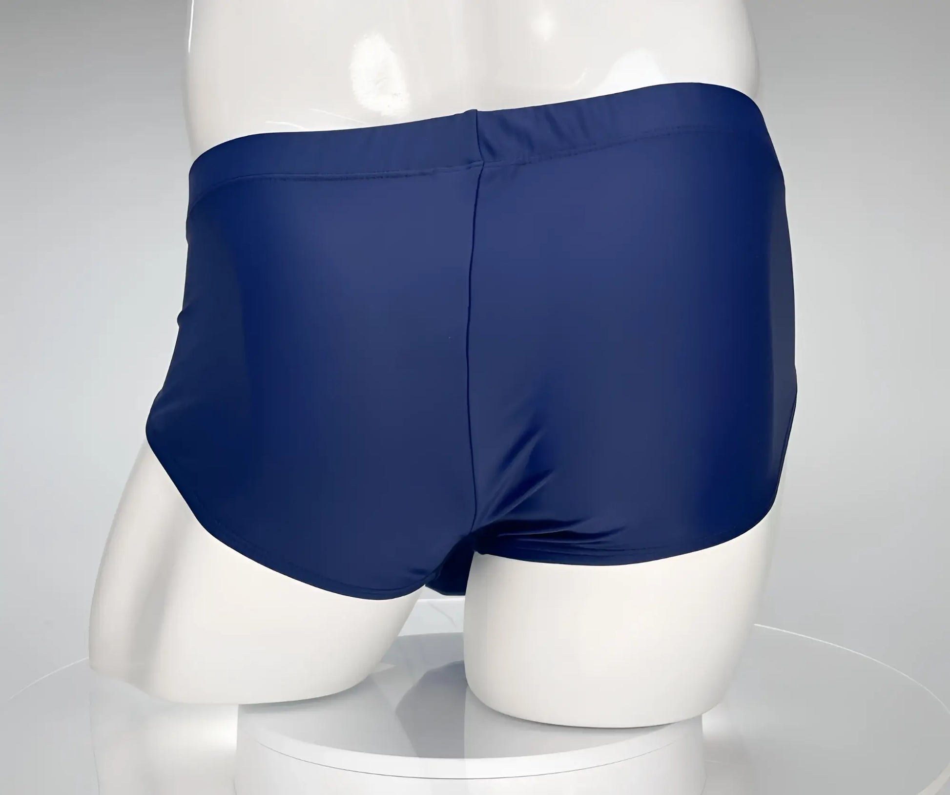 Wildmant monster cock swim brief navy in navy blue with smooth stretchy fabric and simple back seam shown from back side