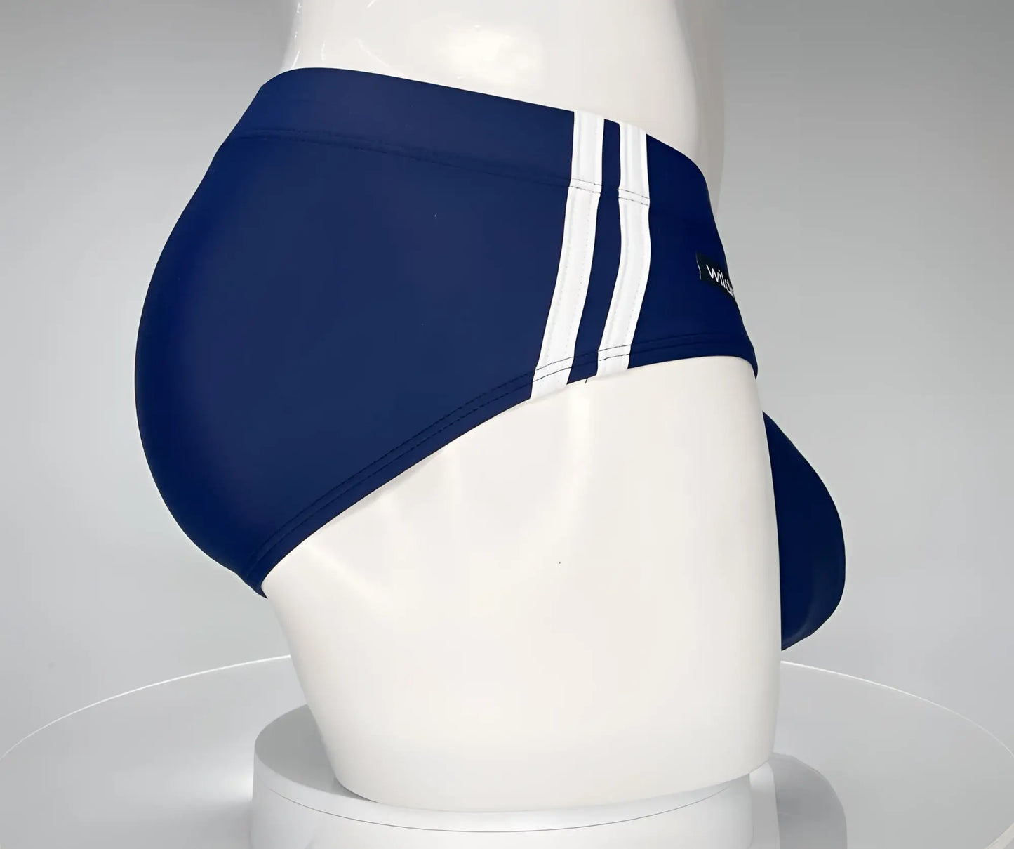 Wildmant monster cock navy swim brief with three white vertical stripes on the side for swimming and beachwear