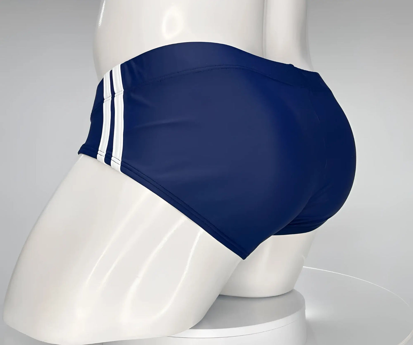 WildmanT monster cock swim brief navy blue with three white vertical stripes on the side for swimming and beachwear