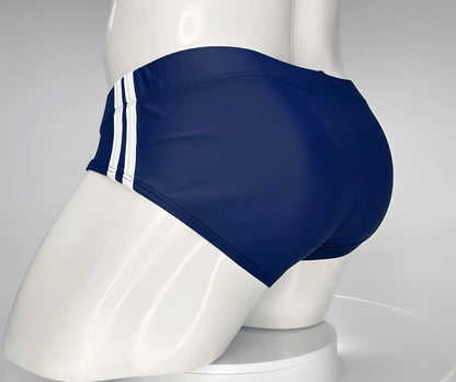WildmanT monster cock swim brief navy blue with three white vertical stripes on the side for swimming and beachwear