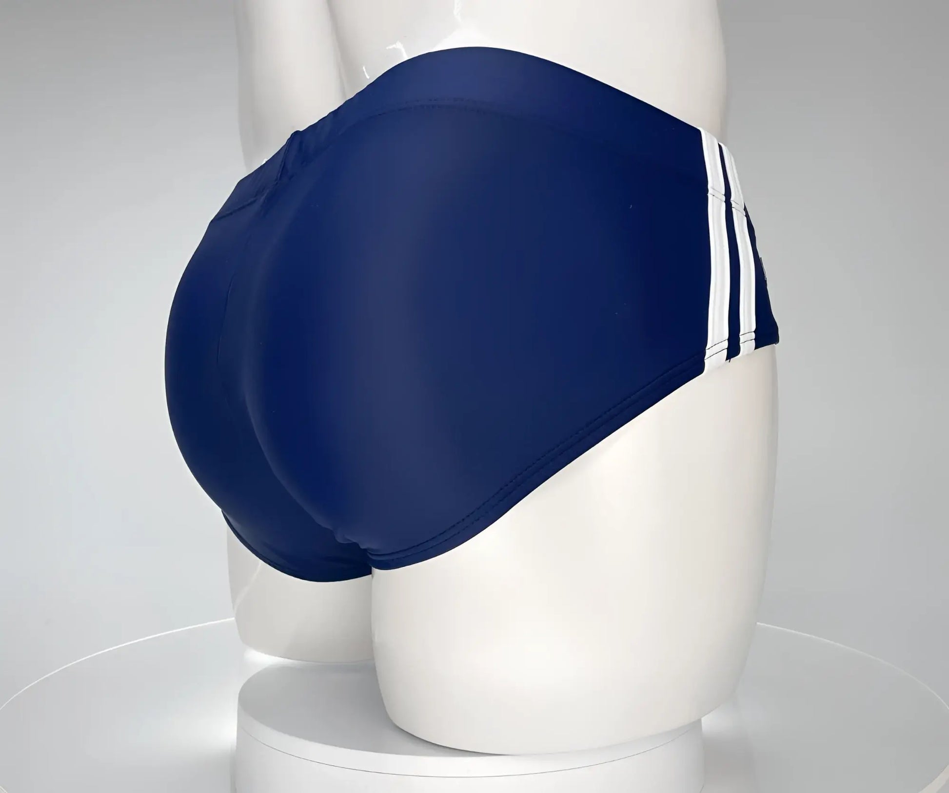 Wildmant monster cock swim brief navy featuring navy blue swim trunks with three white stripes on the side
