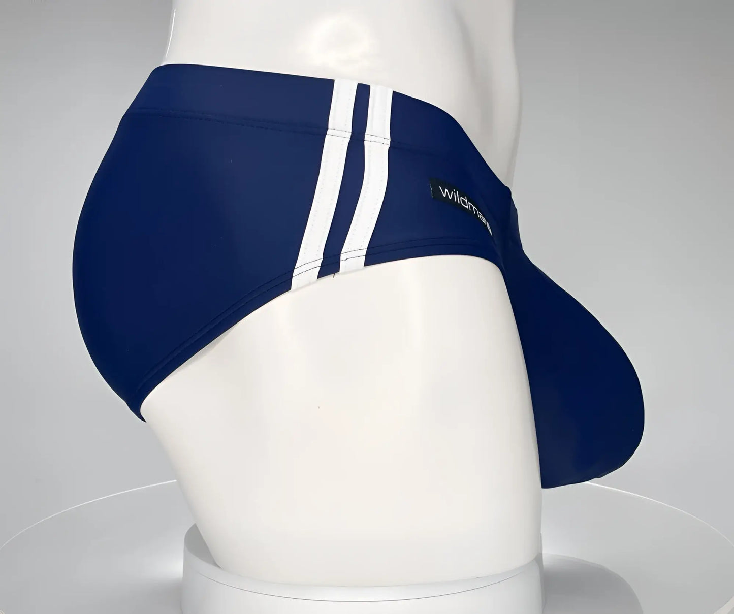 Wildmant monster cock swim brief navy blue swim trunks with three white vertical stripes and wildman logo on side