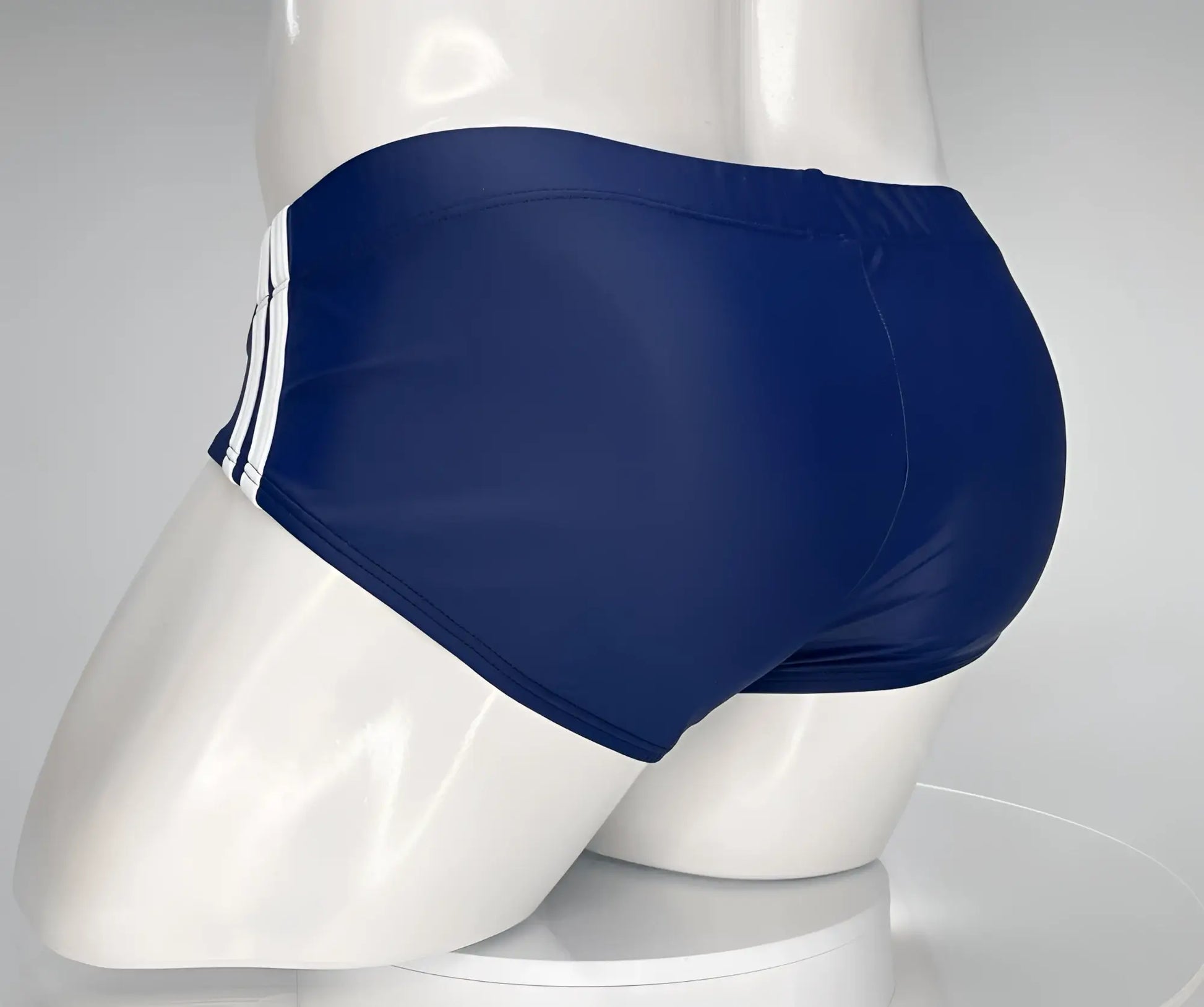 Wildmant monster cock swim brief navy blue swim trunks with three white side stripes displayed on mannequin