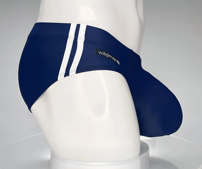 Navy blue wildmanT monster cock swim brief with white side stripes and brand label for swimming and beachwear