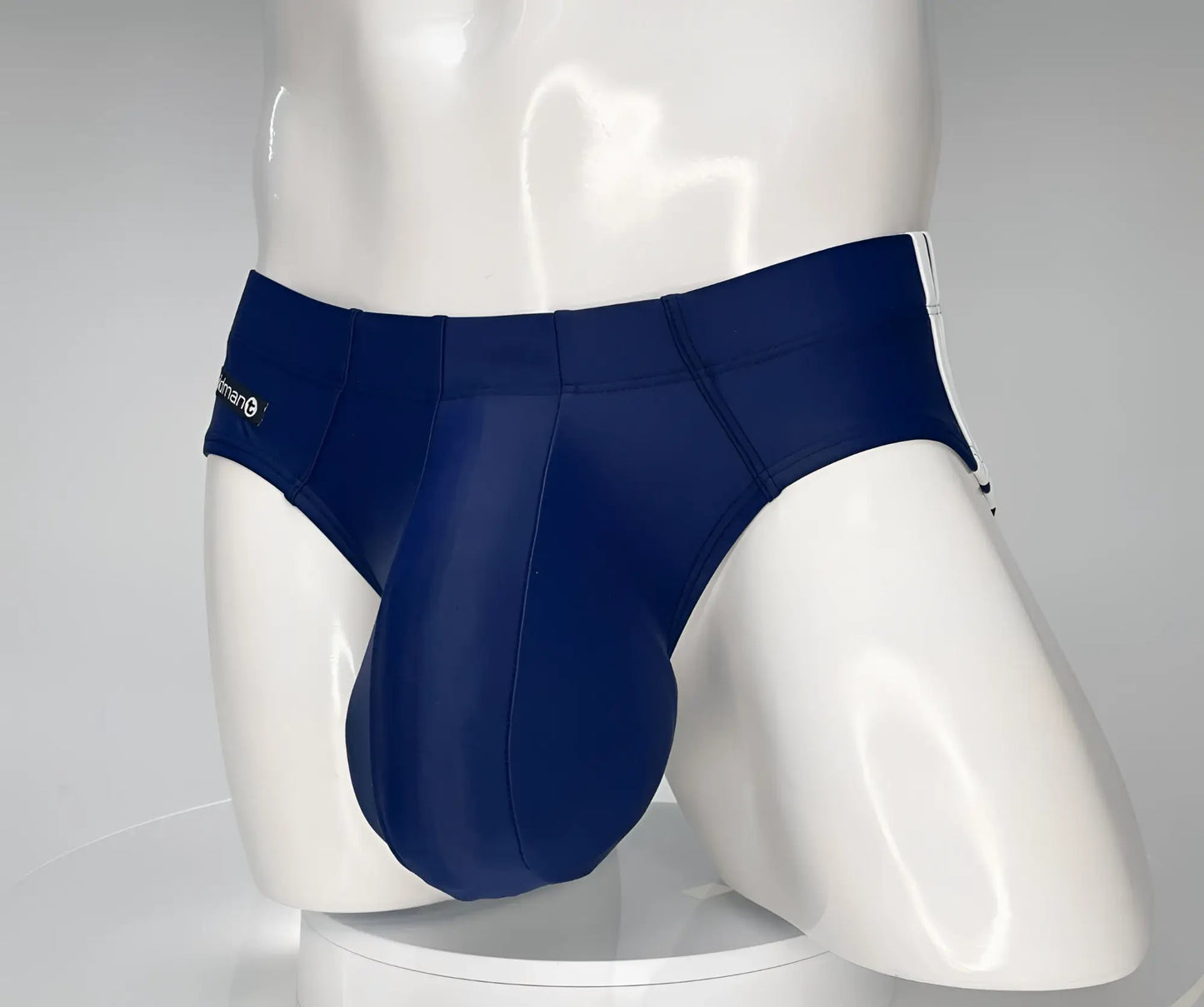 WildmanT monster cock swim brief navy blue with white side stripes and subtle logo on the waistband for swimming