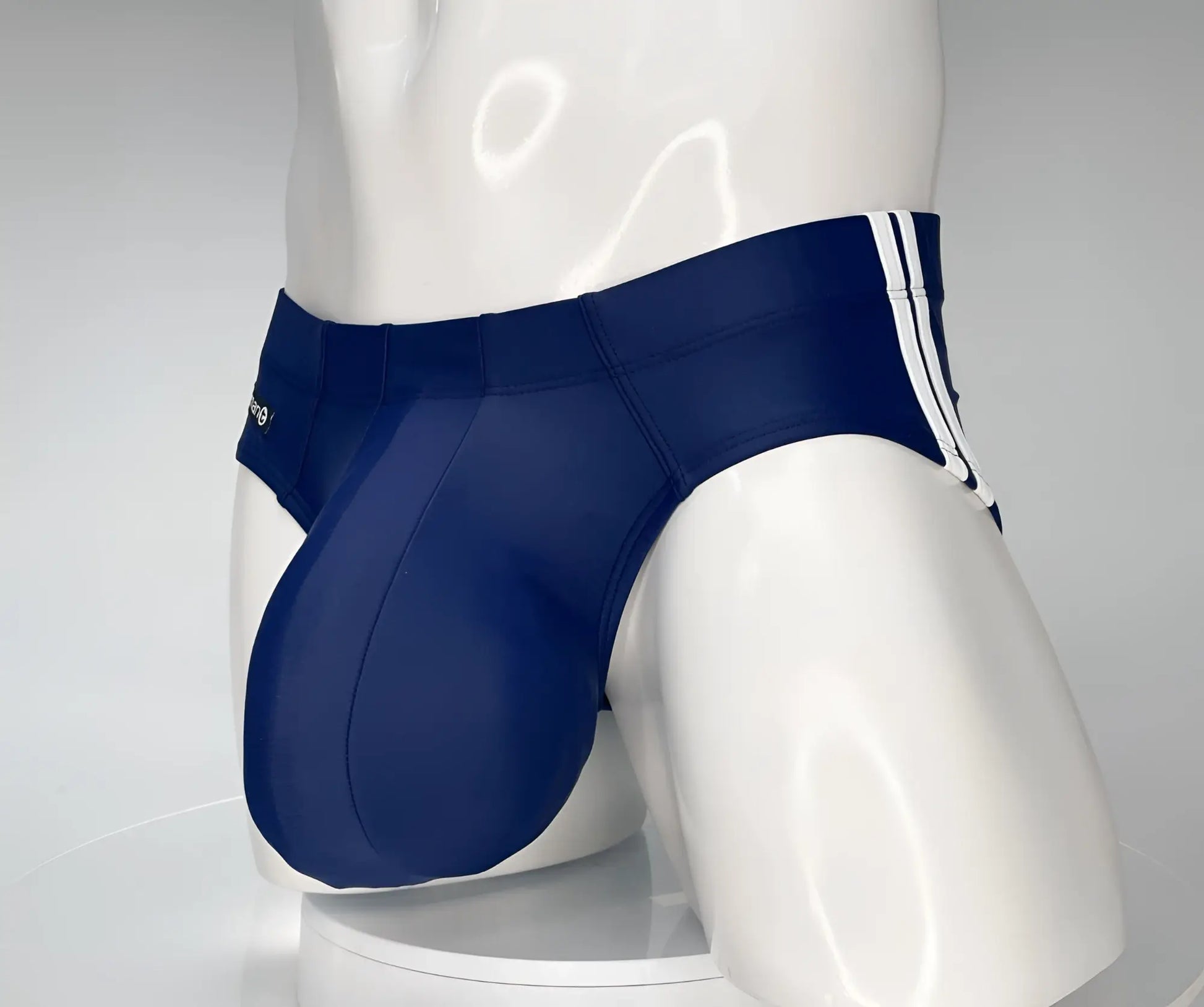 Wildmant monster cock swim brief navy featuring navy blue fabric with white striped side panels for swimming