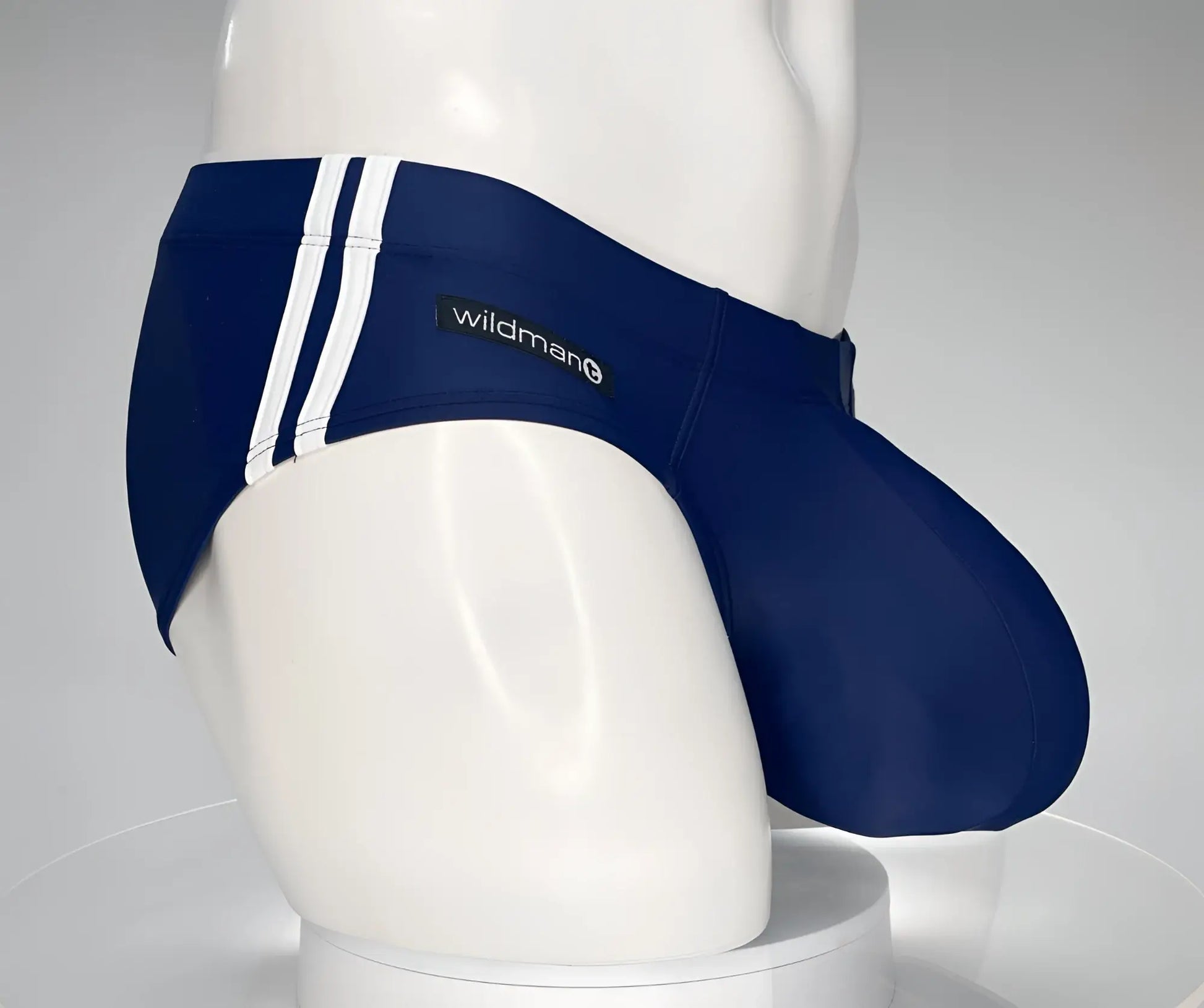 WildmanT monster cock swim brief navy with white vertical stripes and wildman brand label swim trunks for men