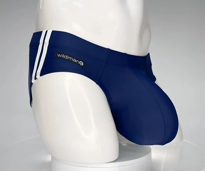 Navy blue WildmanT Monster Cock swim brief with white side stripes and wildman logo on the waistband