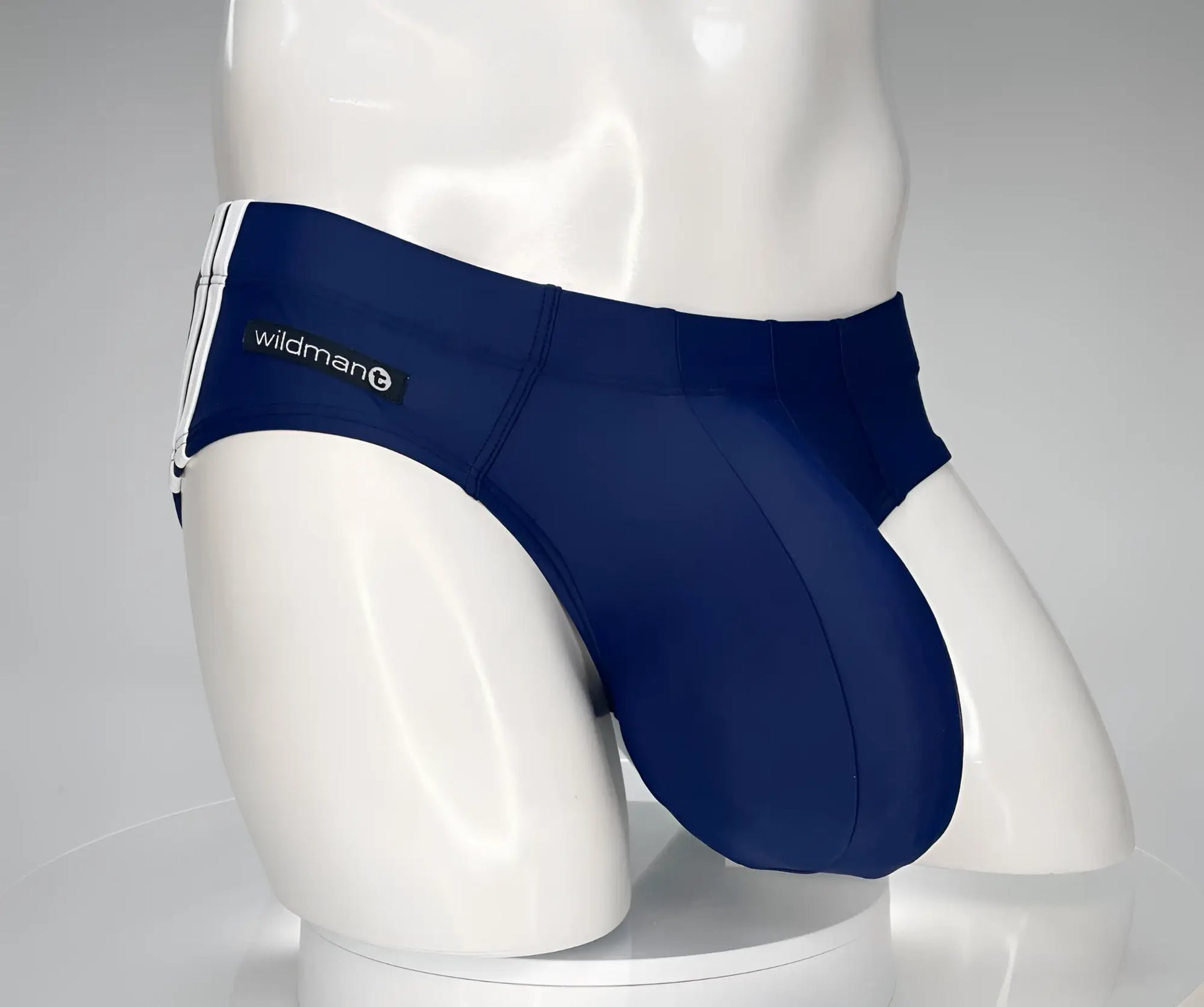 Navy blue wildman swim trunks with white side stripes designed as a monster cock swim brief for swimming
