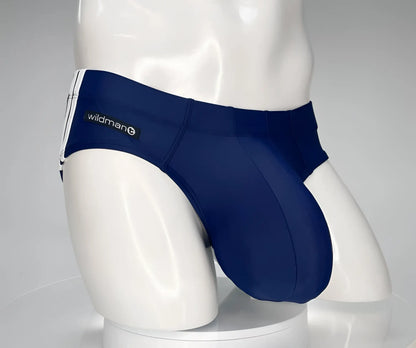 Navy blue wildman swim trunks with white side stripes designed as a monster cock swim brief for swimming