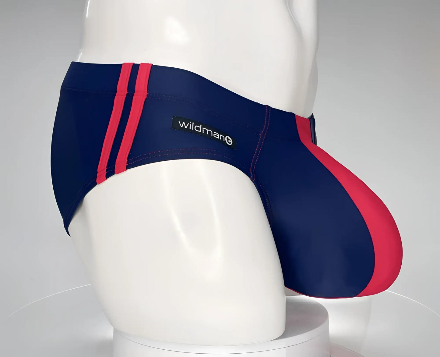 WildmanT monster cock swim brief in navy and red striped design with wildman brand label for swimwear use
