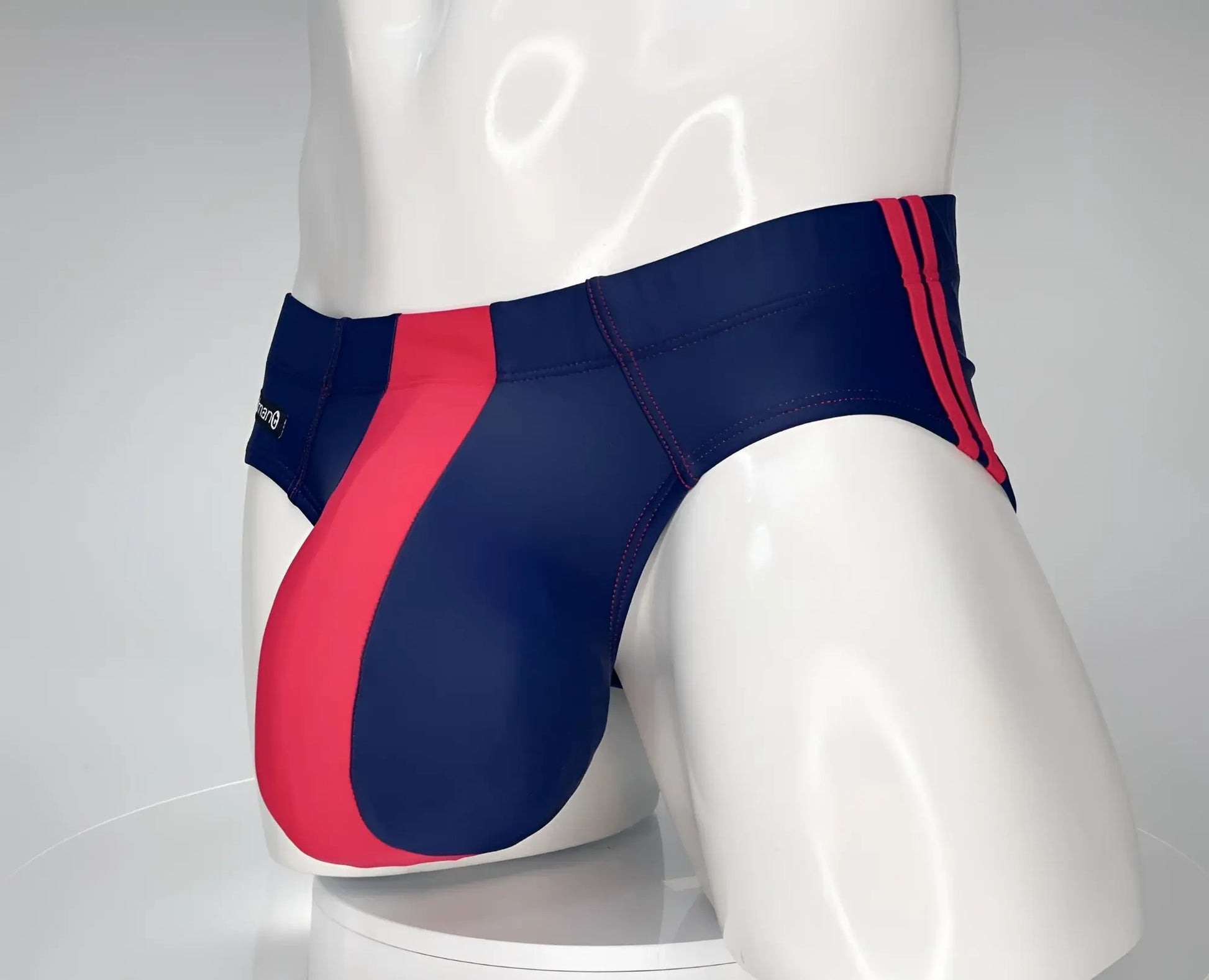 Wildmant monster cock swim brief in navy and red featuring bold diagonal stripe design for swimming and beachwear
