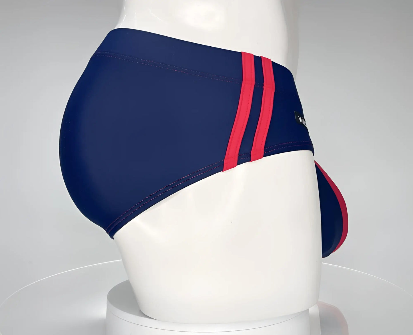 Wildmant monster cock swim brief navy with bold red side stripes made of smooth stretchy fabric for swimming