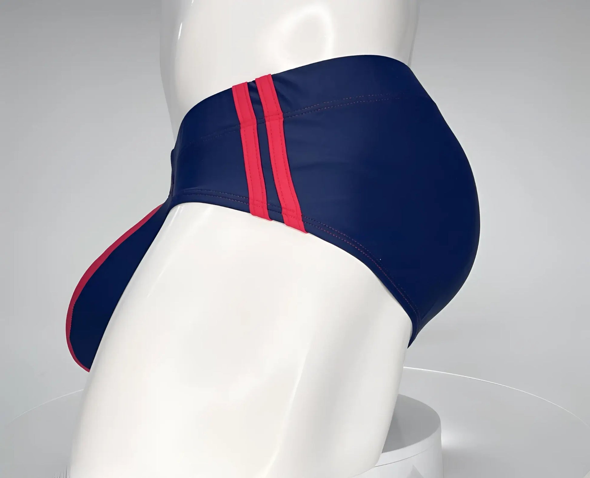 Wildmant monster cock swim brief navy with bold red side stripes designed for comfortable swimwear use