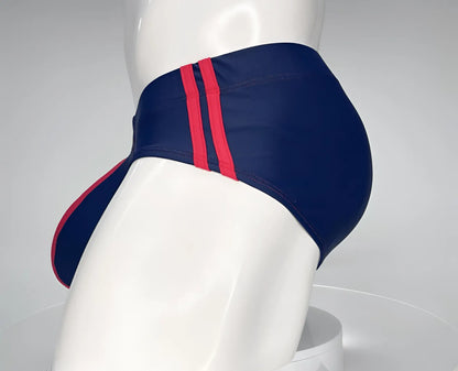 Wildmant monster cock swim brief navy with bold red side stripes designed for comfortable swimwear use