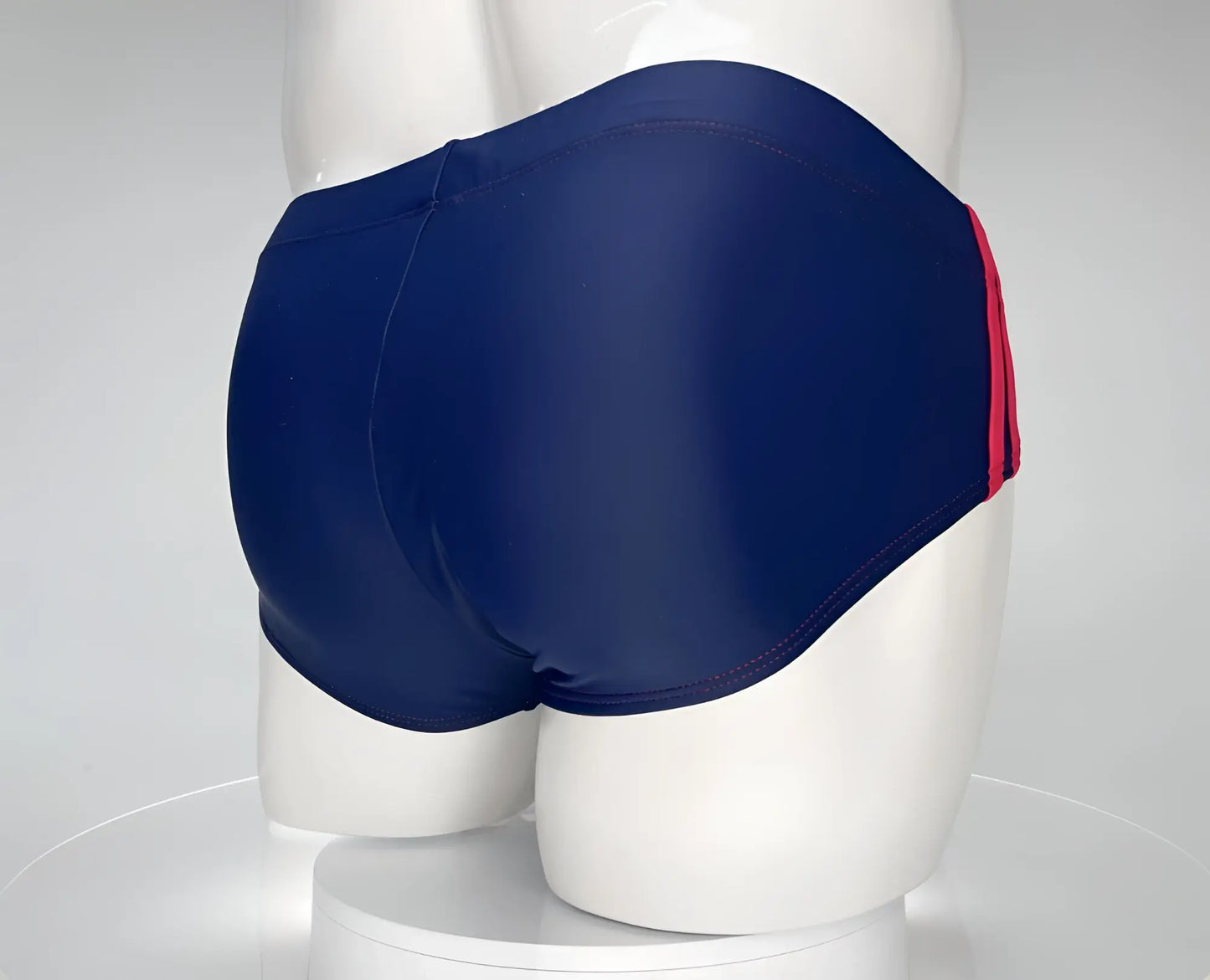 Wildmant monster cock swim brief in navy blue with a red side stripe designed for swimming and beachwear
