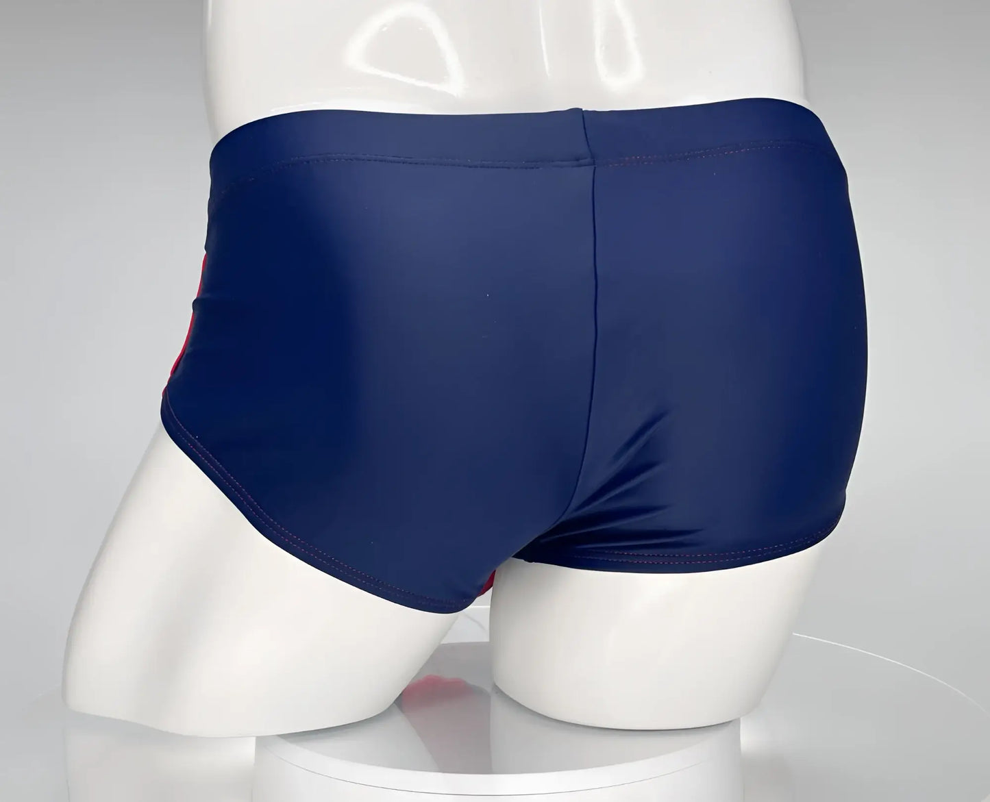 Wildmant monster cock swim brief navy with subtle red side stripe designed for swimming and beach use