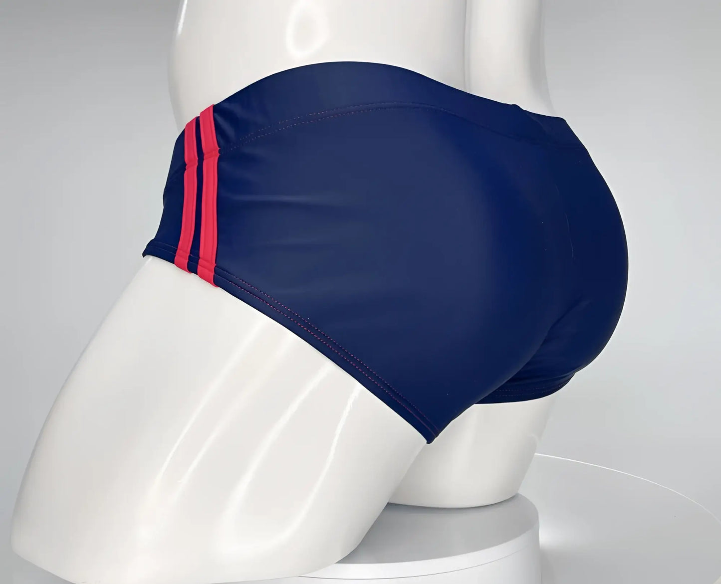WildmanT monster cock navy swim brief with bold red stripes on the side seam for beach and pool use