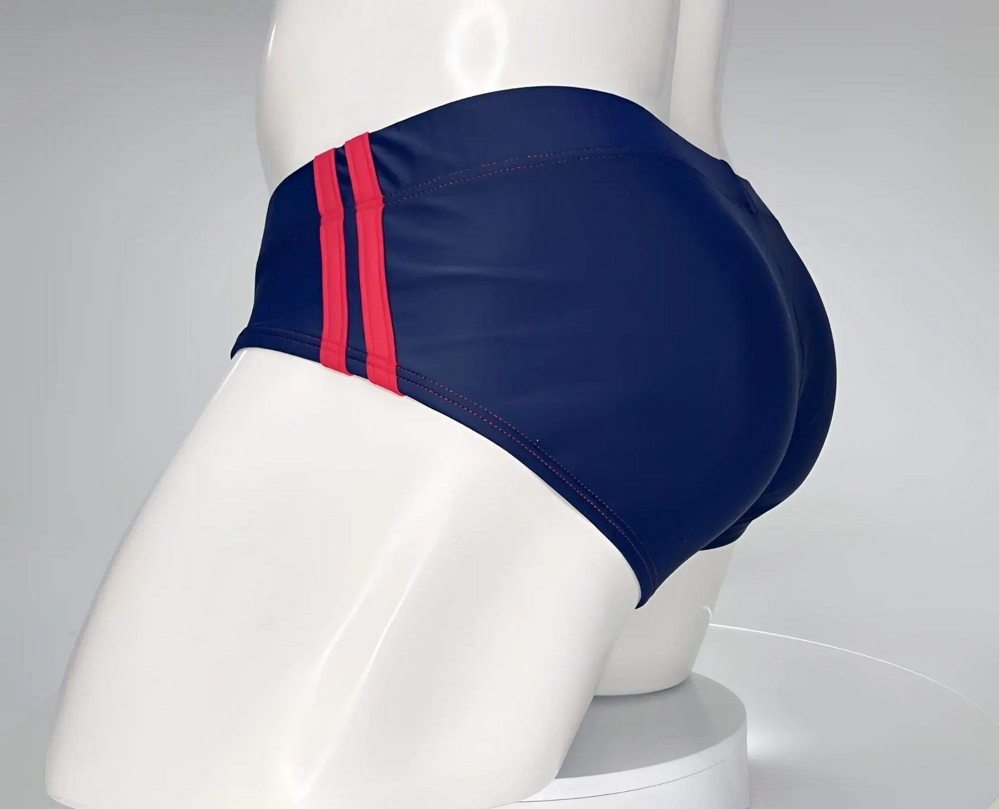 Navy blue WildmanT Monster Cock swim brief with two bold red stripes on the side for beach and pool use