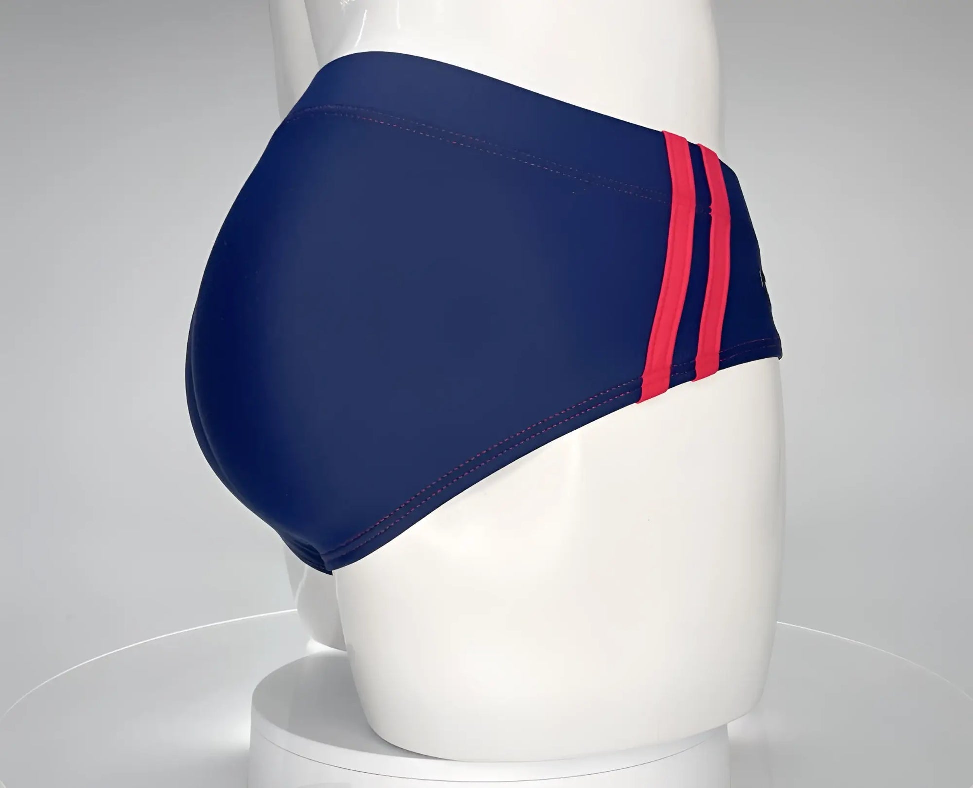 WildmanT monster cock navy swim brief with two bold red stripes along the sides for swimming and beach use