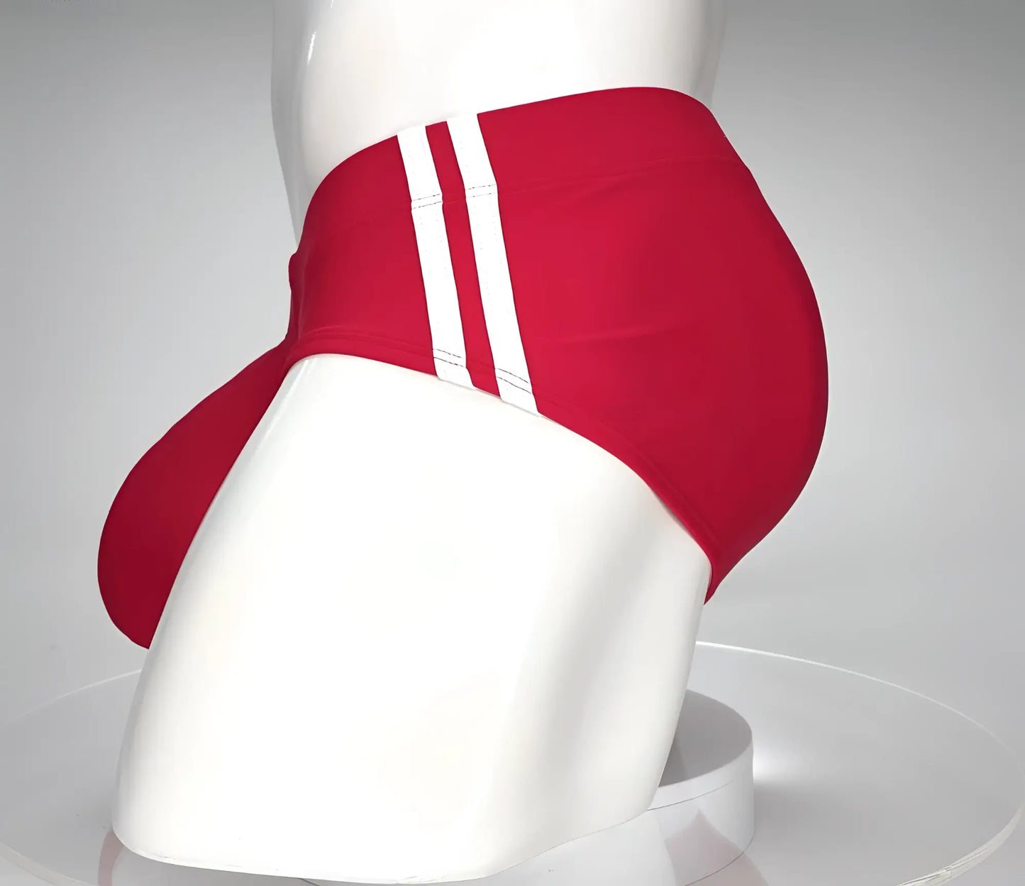 WildmanT monster cock swim brief in red with three white stripes down the side for athletic swim use