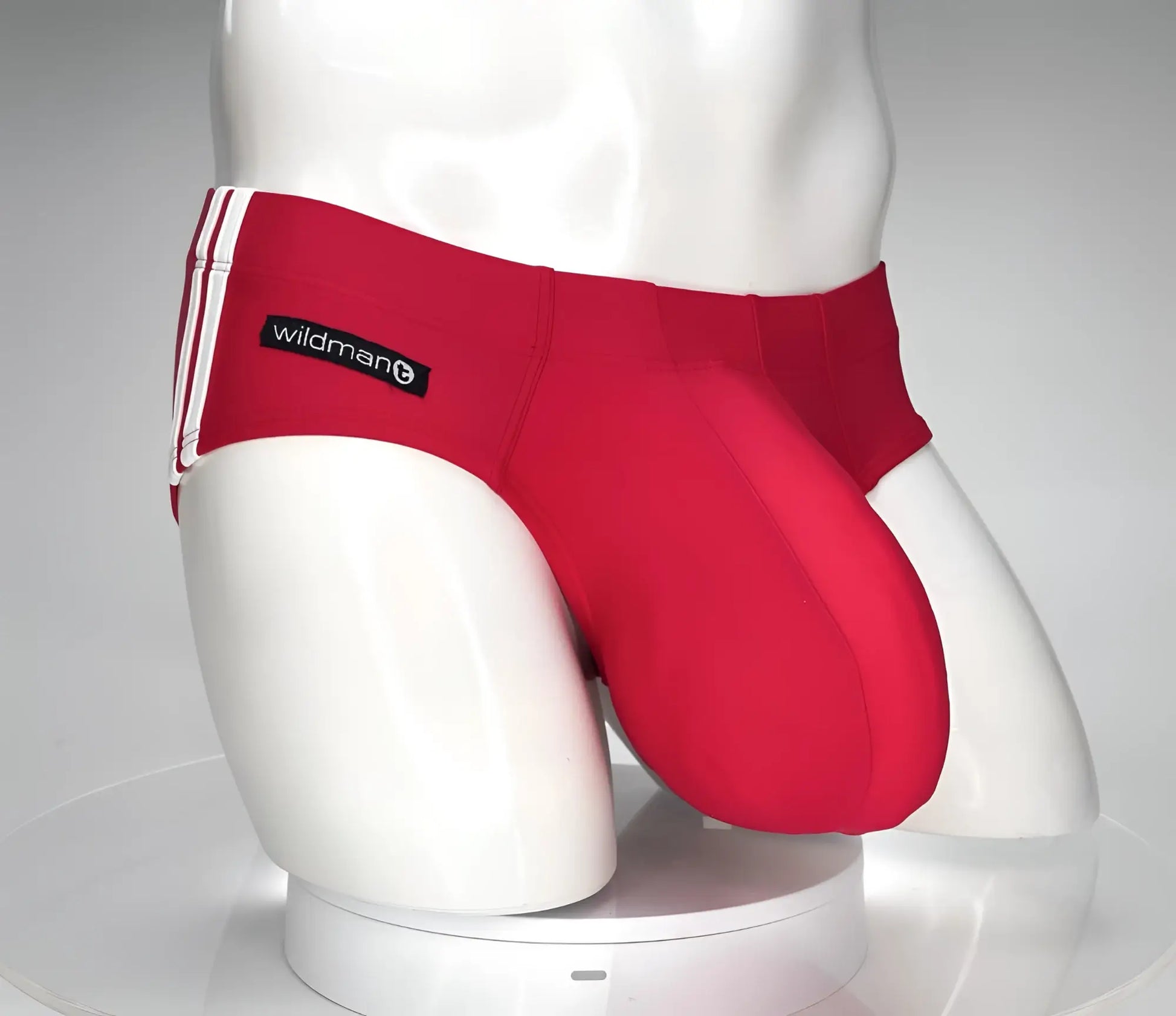 WildmanT monster cock swim brief in red with white side stripes and black wildman brand label for athletic use