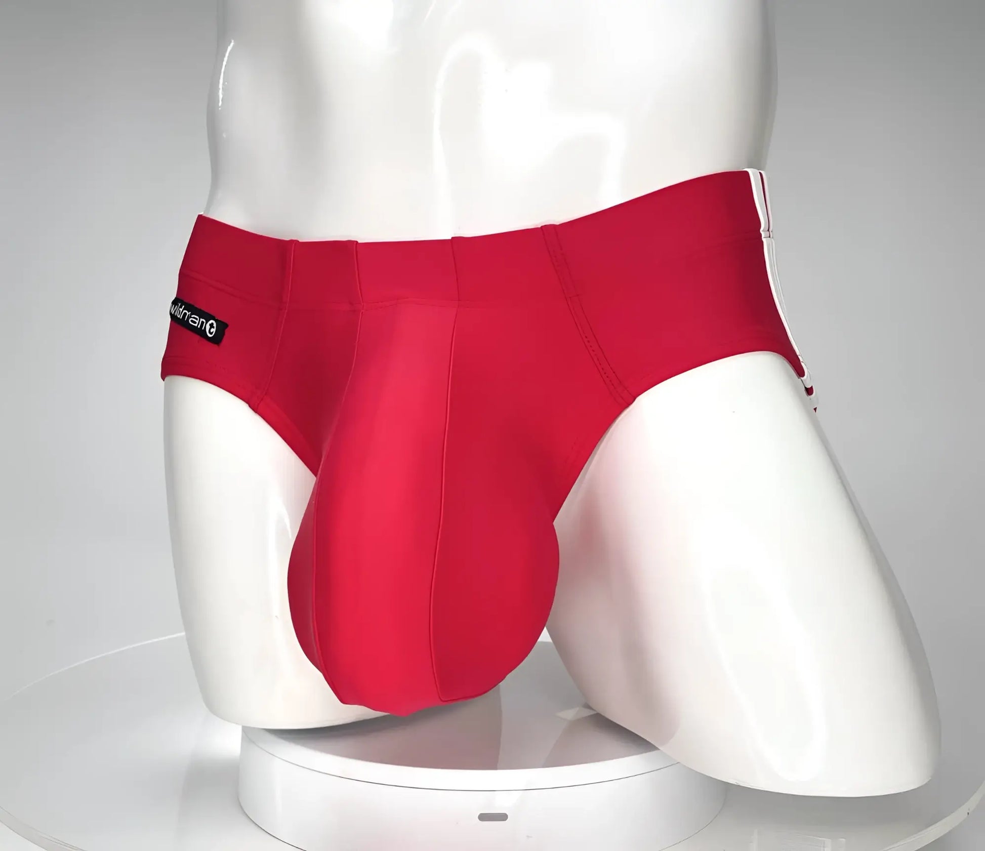 Red men’s WildmanT Monster Cock swim brief with white trim and black brand tag on waistband