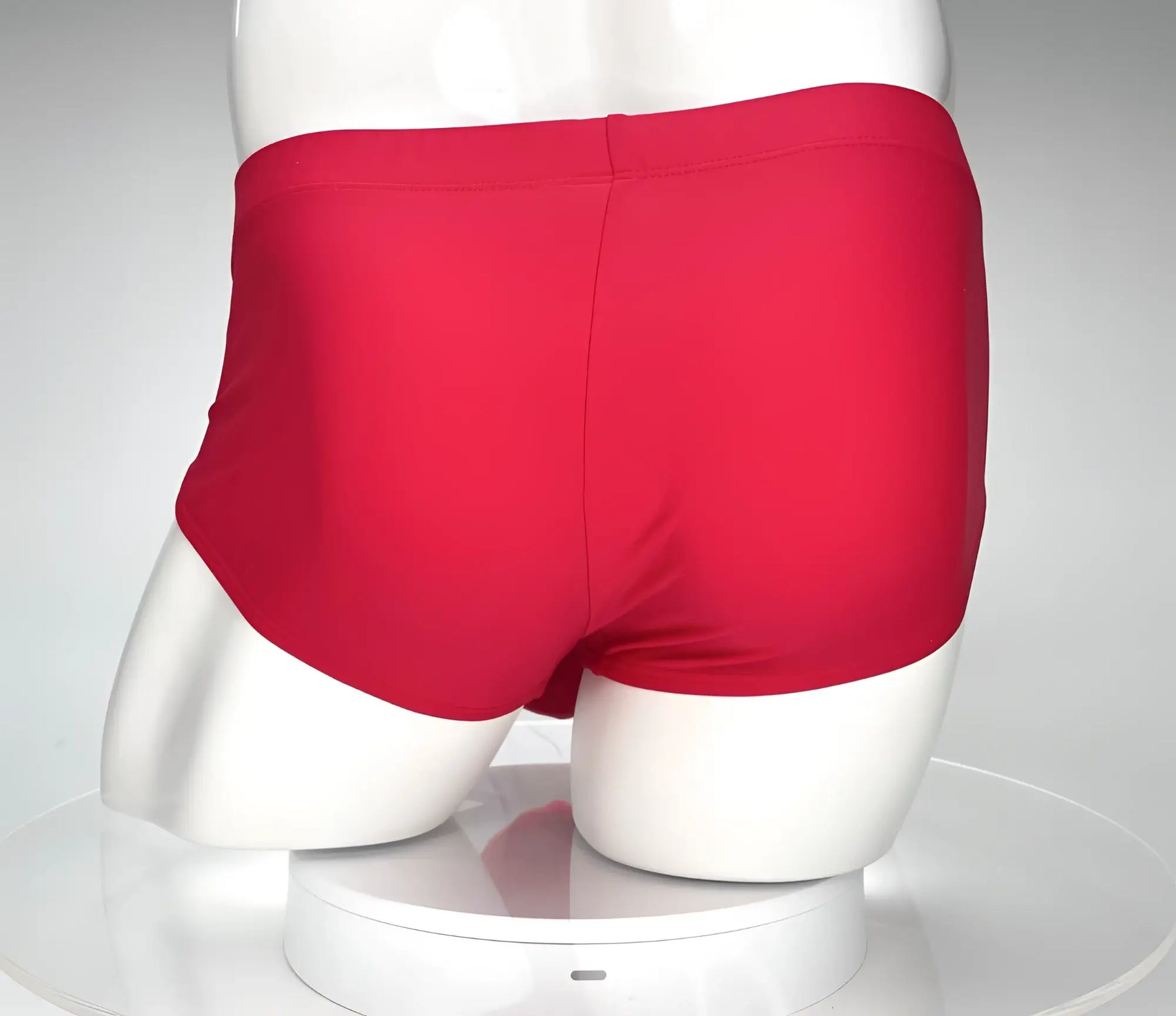 Red swim brief from wildmant monster cock collection displayed on mannequin highlighting front design