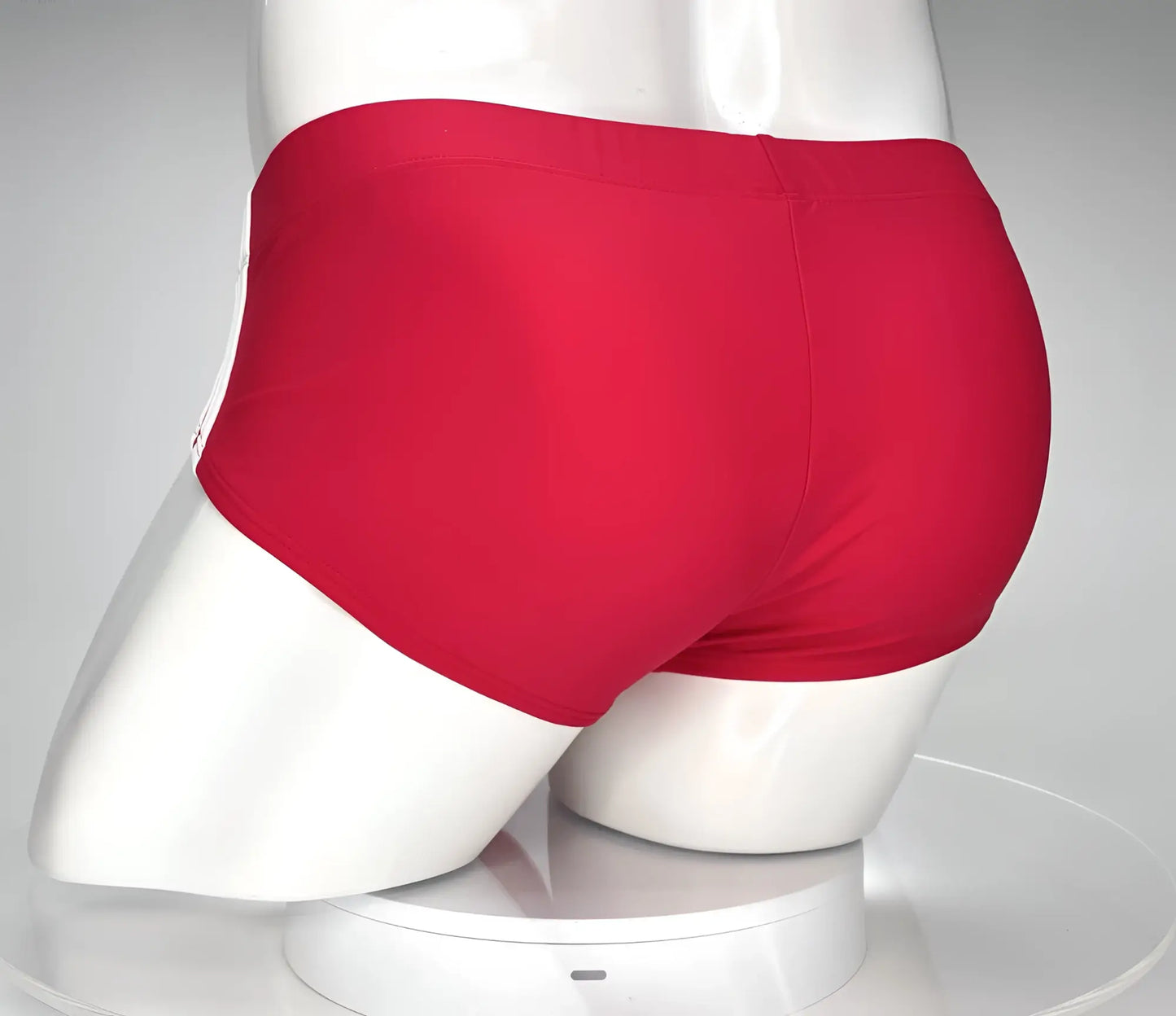 Wildmant monster cock swim brief red swim trunks with smooth form-fitting fabric and subtle white side stripe