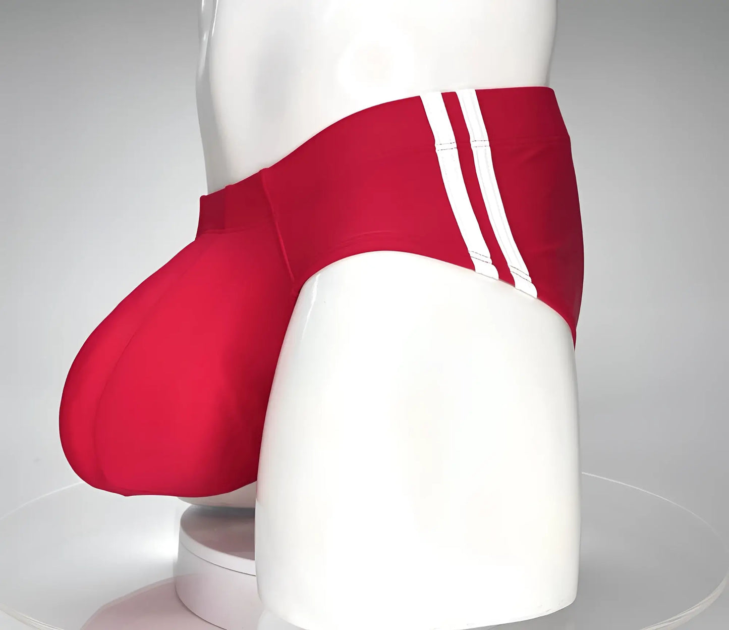 WildmanT Monster Cock red swim brief with three white stripes on the side featuring a sleek athletic design