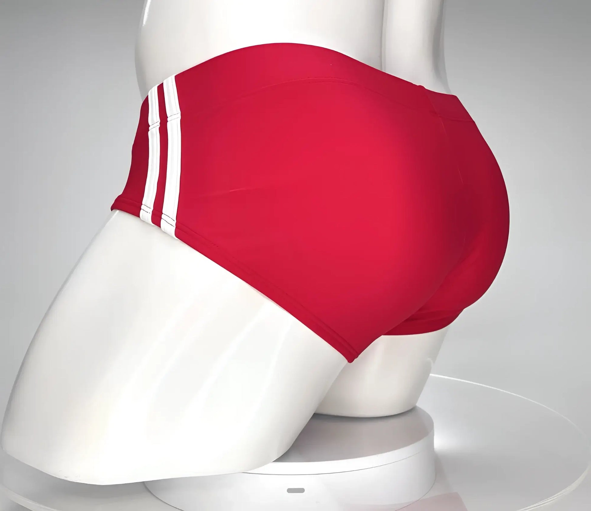 WildmanT Monster Cock swim brief red featuring three white stripes on the side displayed on a mannequin