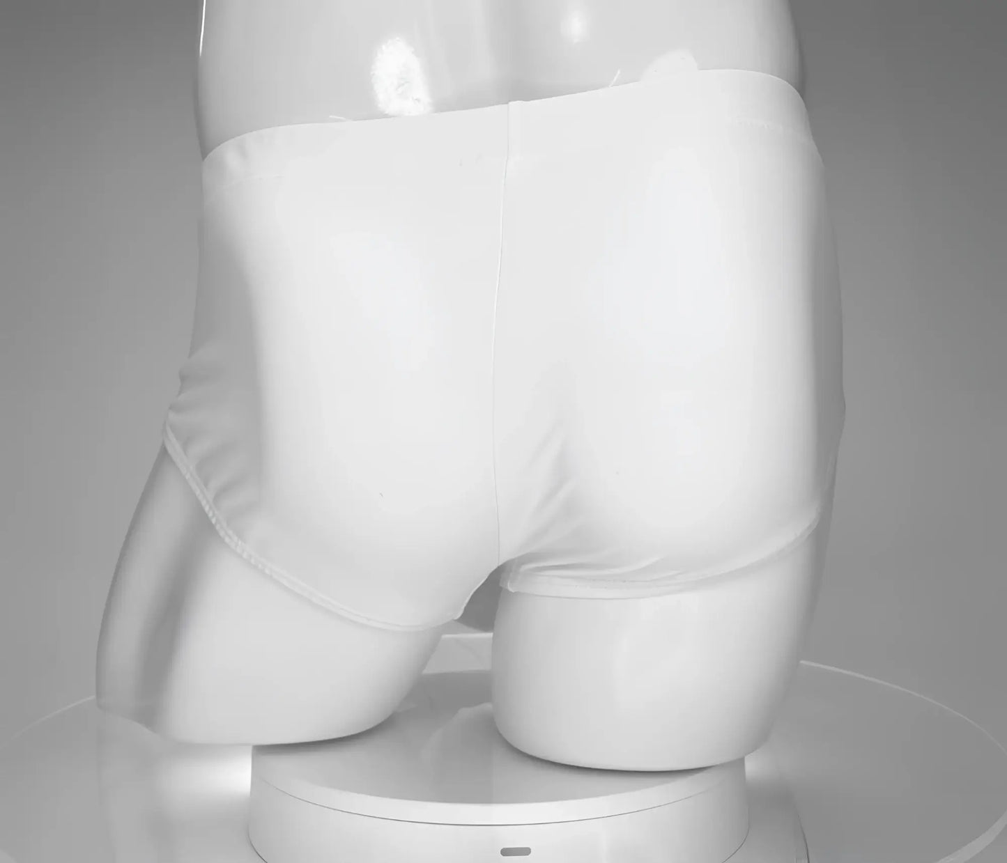 White briefs swim brief by wildmant featuring a monster cock design displayed on a mannequin front view