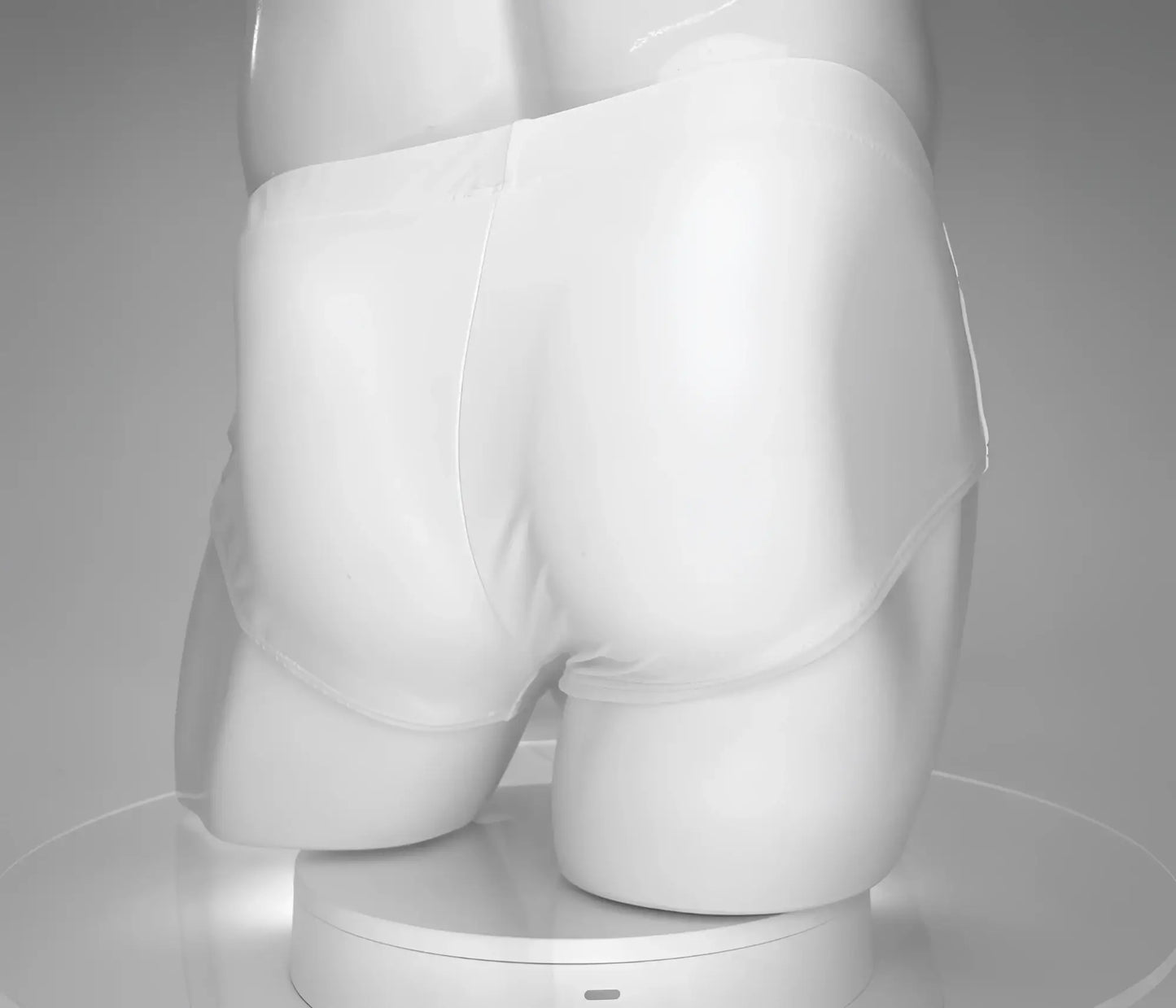 WildmanT monster cock white swim brief displayed on a mannequin showing the front design in stretch fabric