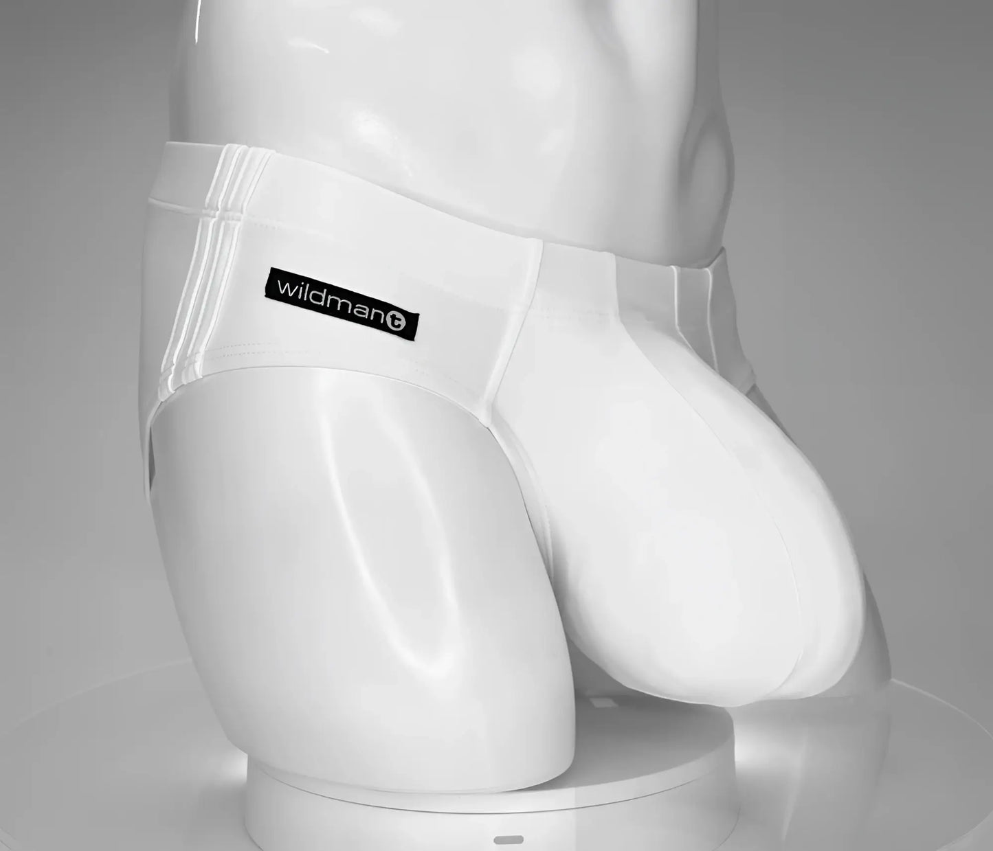 White men’s briefs swim brief with black wildman brand label on waistband named wildmant monster cock swim brief white