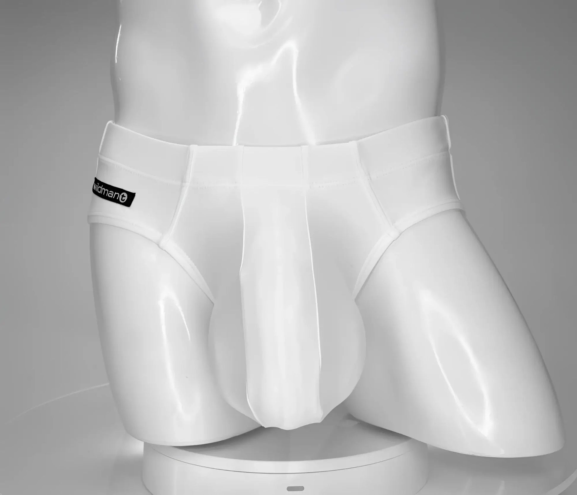 White wildmant monster cock swim brief with sleek form-fitting design and subtle brand label on waistband