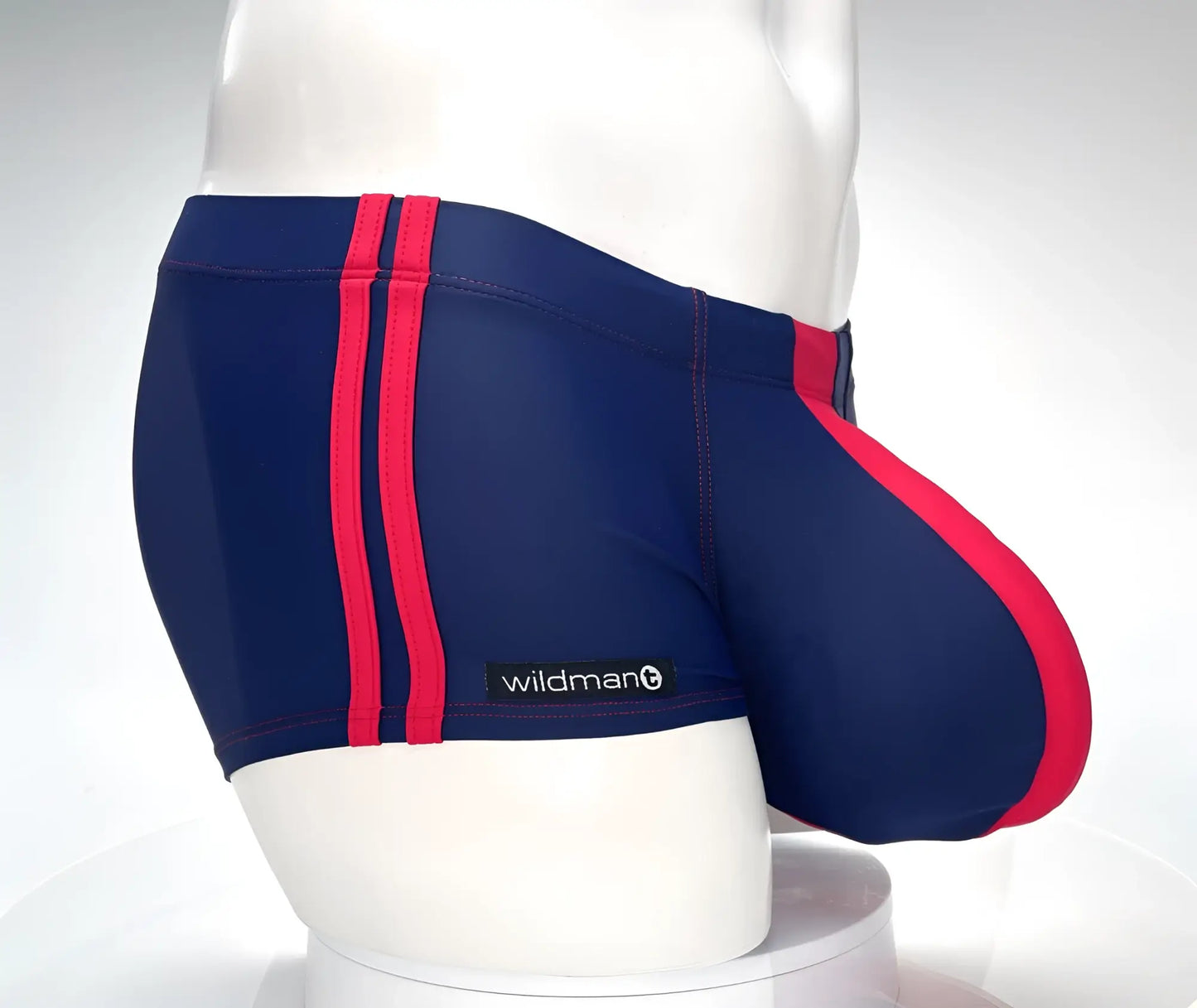 Navy blue swim square cut trunks with bold red stripes and wildman brand label for swimming and beachwear