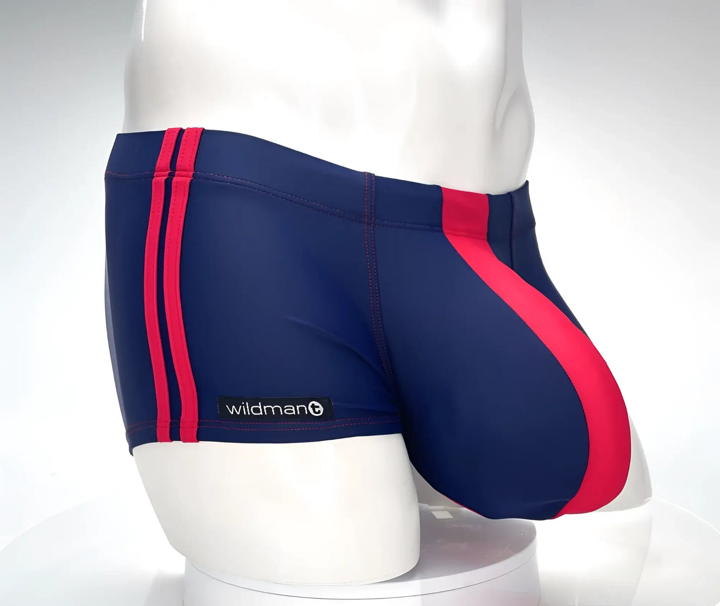 Navy blue wildman swim square cut trunks with bold red side and diagonal leg stripes for monster cock fit
