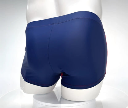 Navy blue WildmanT Monster Cock swim square cut trunks with red trim along the side seams for swimming