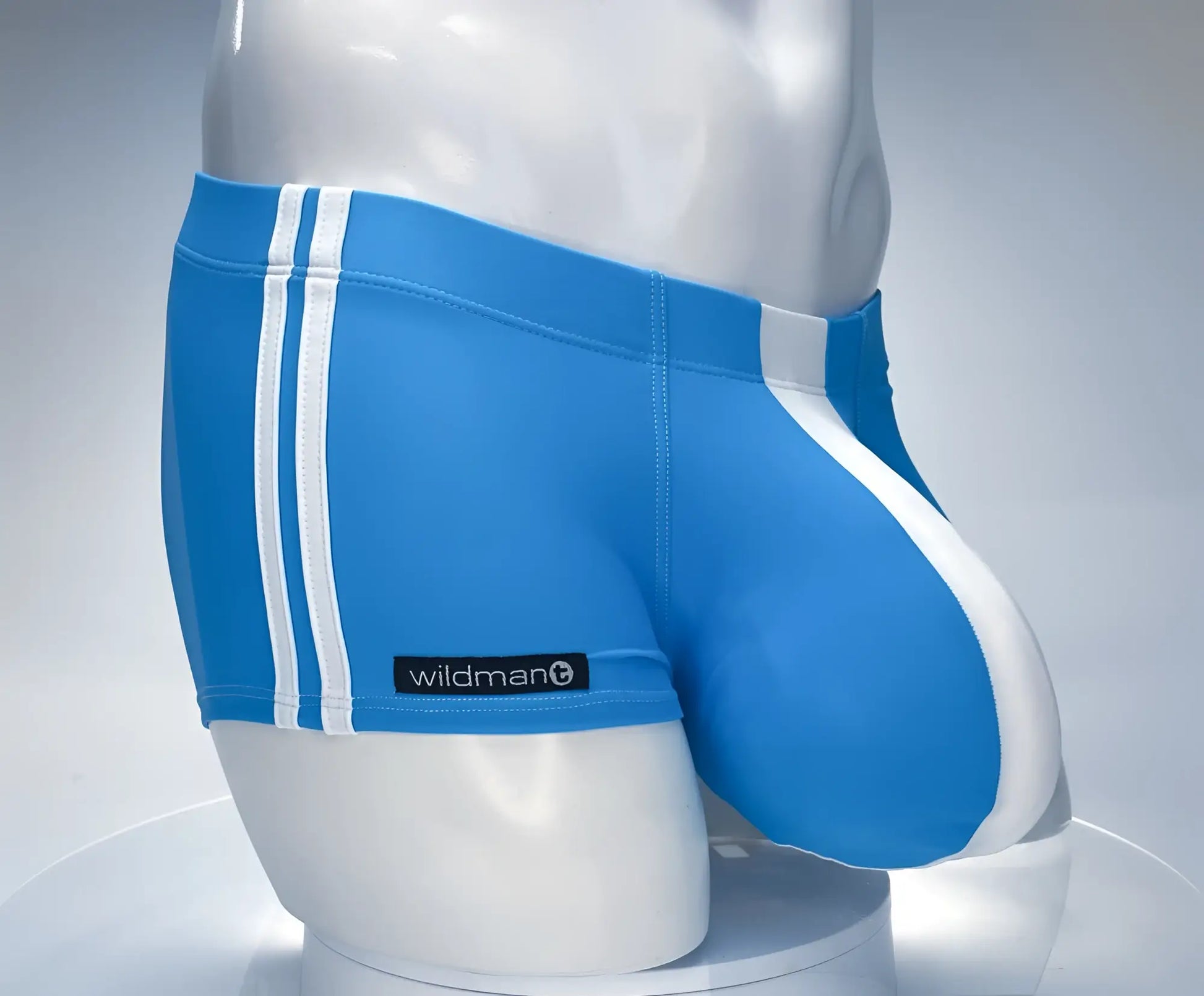 Blue swim trunks with white stripes and wildman label in a square cut teal and white design for swimming use