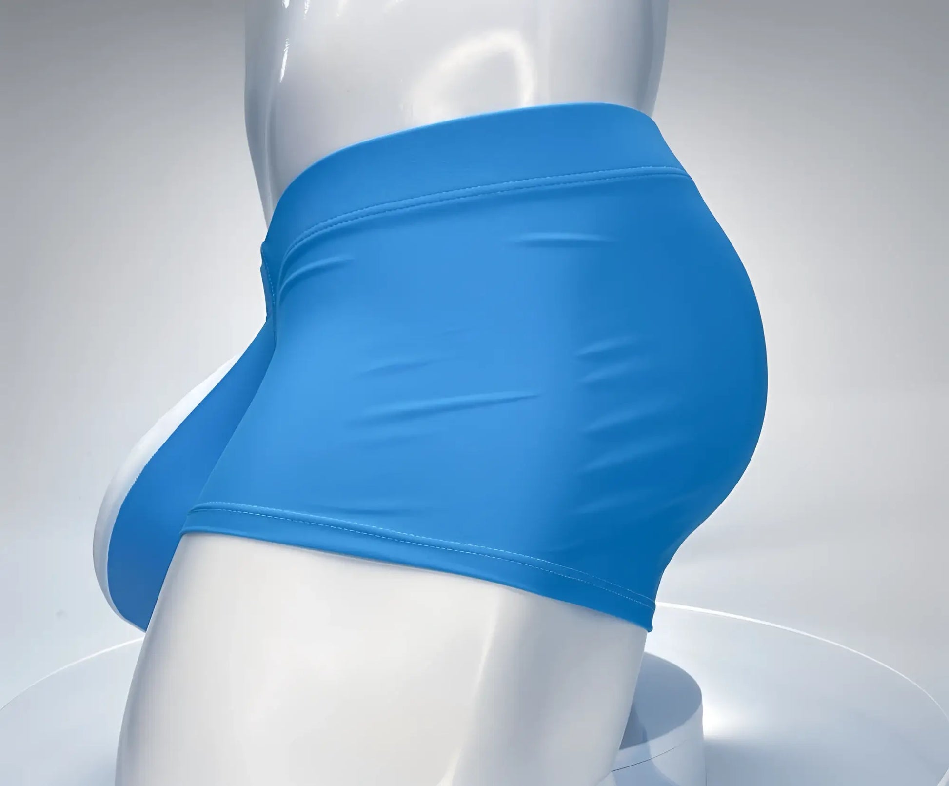 Teal and white WildmanT square-cut swim trunks on a white mannequin torso, side view.