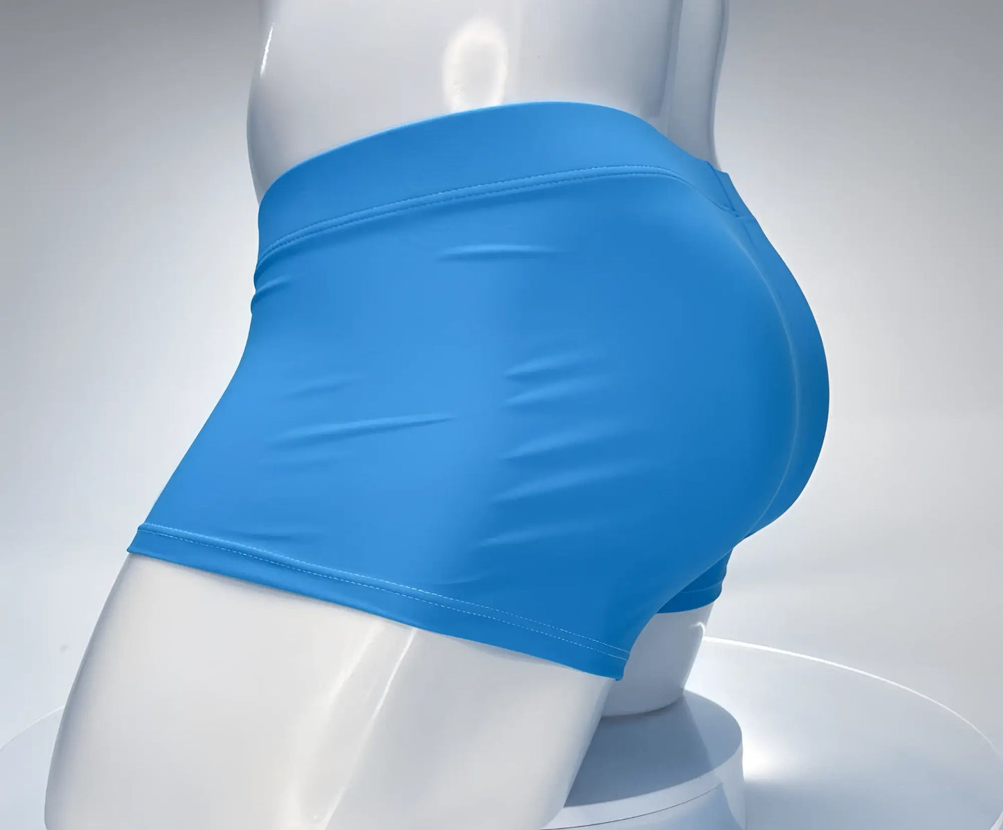 Teal, square-cut swim trunks on a white mannequin, featuring a smooth, form-fitting design and flat-lock stitching.