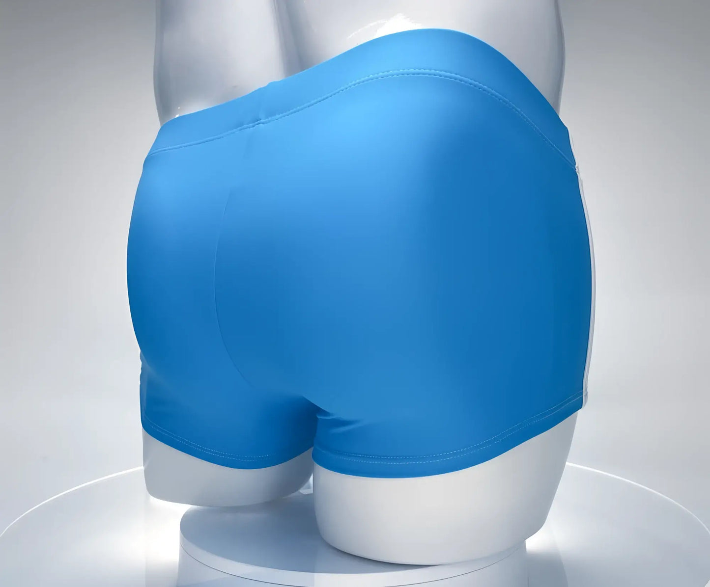 Teal and white WildmanT square-cut swim trunks on a white mannequin, viewed from the rear.