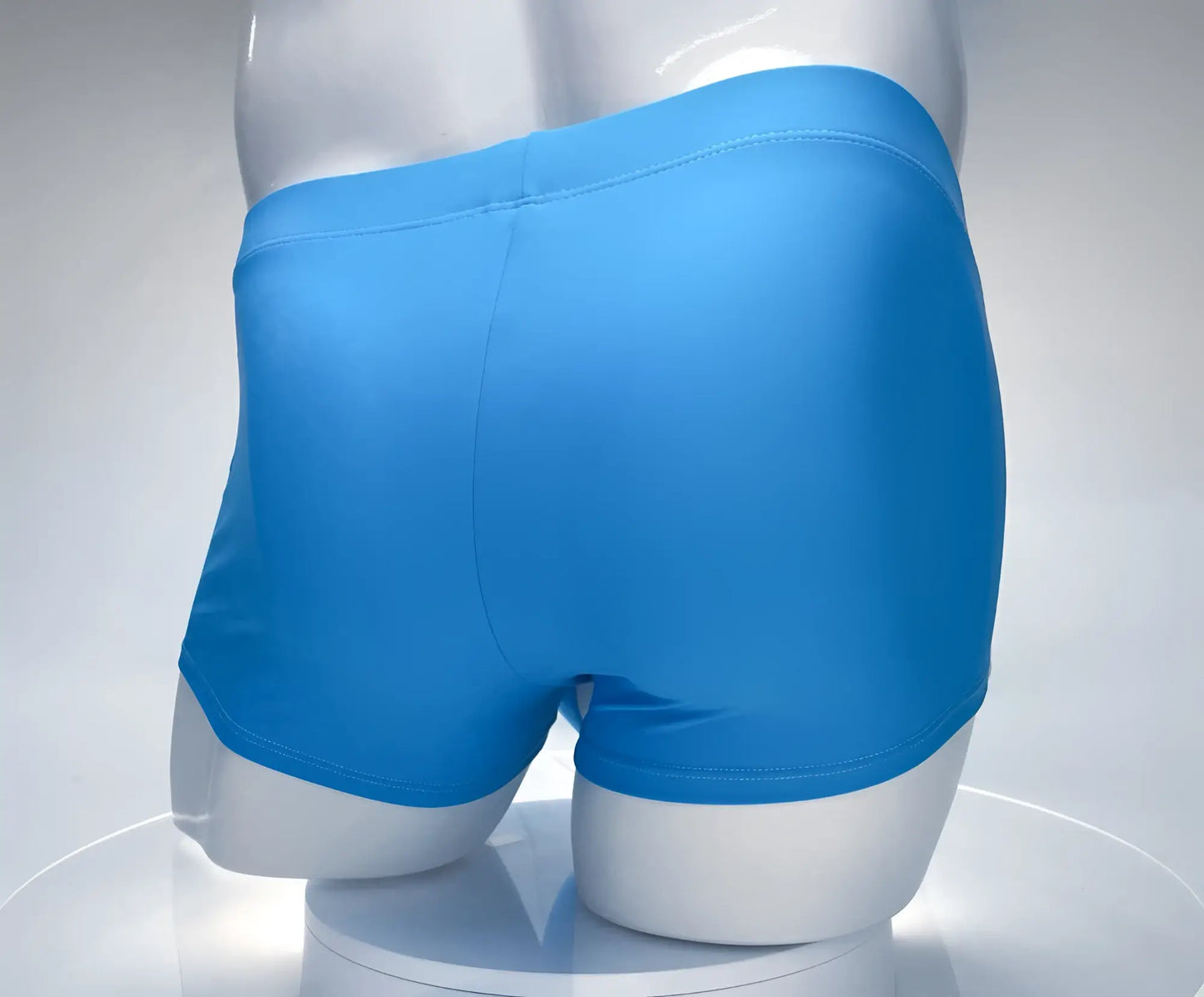 Bright blue smooth textured men’s boxer briefs wildmant monster cock swim square cut teal white on mannequin