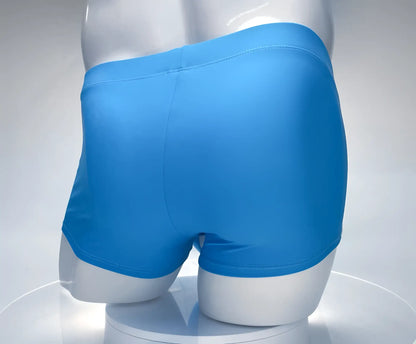 Bright blue smooth textured men’s boxer briefs wildmant monster cock swim square cut teal white on mannequin